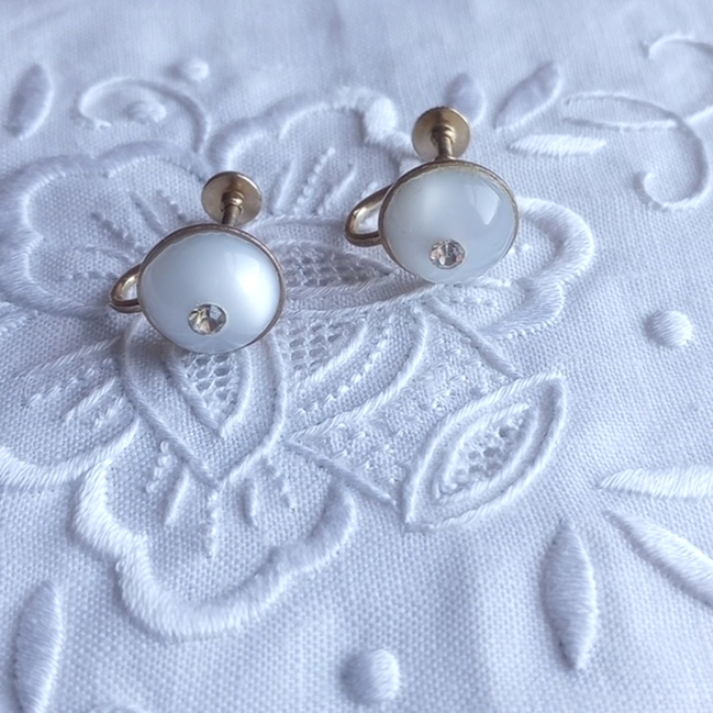 Button style white moon glow with center rhinestone screw back earrings